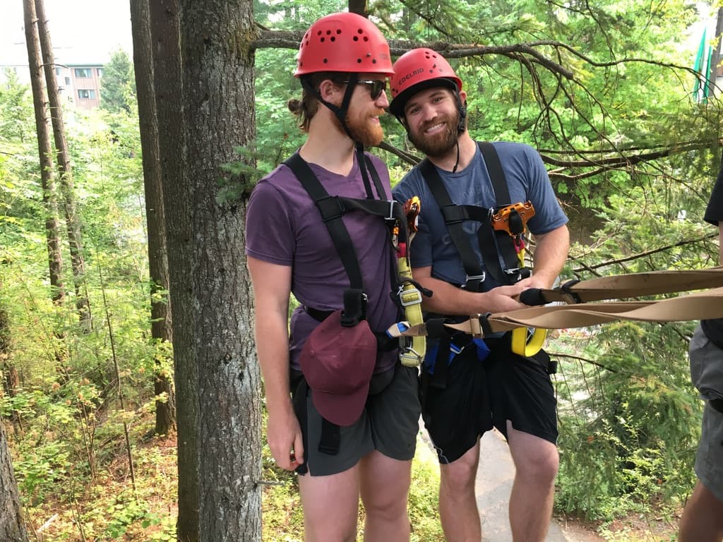 Garrett and a friend zip lining in the trees